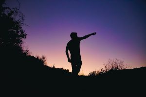 A man pointing to depict purpose as the guide for companies